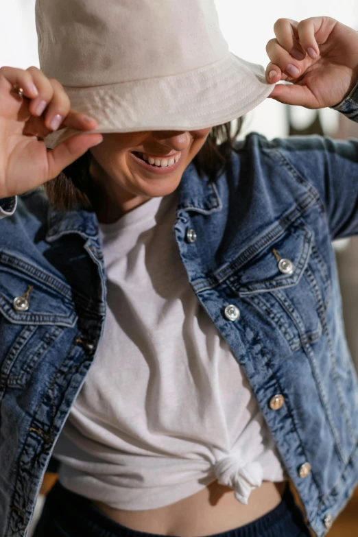 a women wearing a white hat is looking down