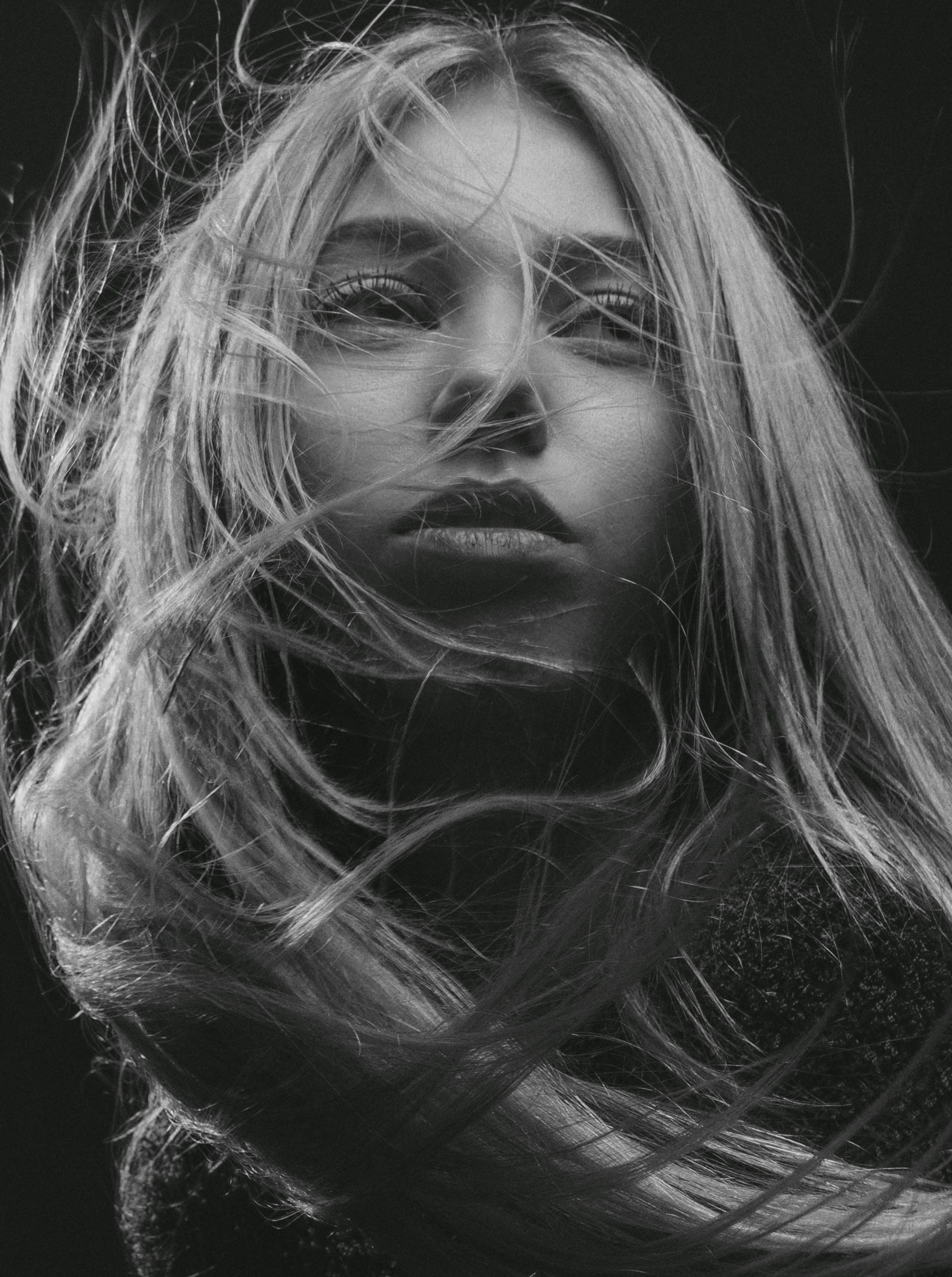 a woman with long hair blowing in the wind, a black and white photo, inspired by irakli nadar, pexels contest winner, process art, chloe moretz, closeup!!!!!!, photography alexey gurylev, extremely long thick blond hair