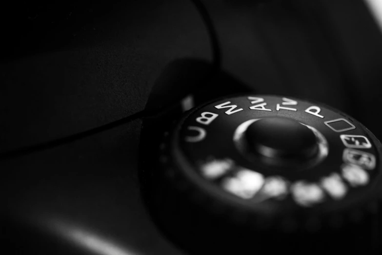 a close up of a dial on a camera, by Adam Chmielowski, medium format. soft light, monochromatic photo, canon 1 d, car photography