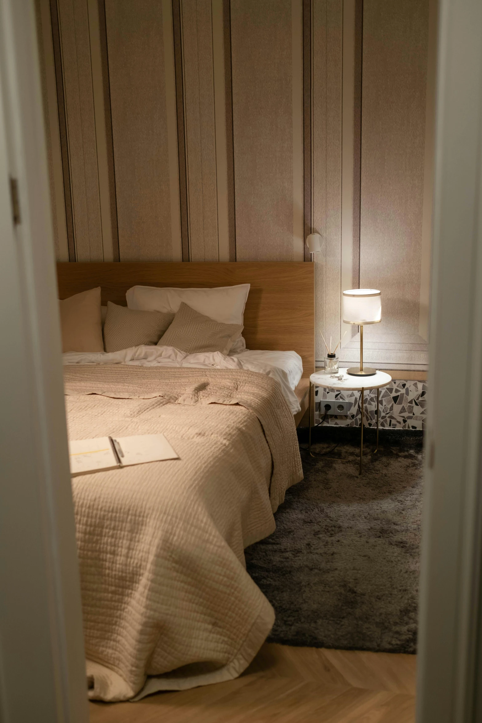 the view from a door of a bed in a room with wooden walls