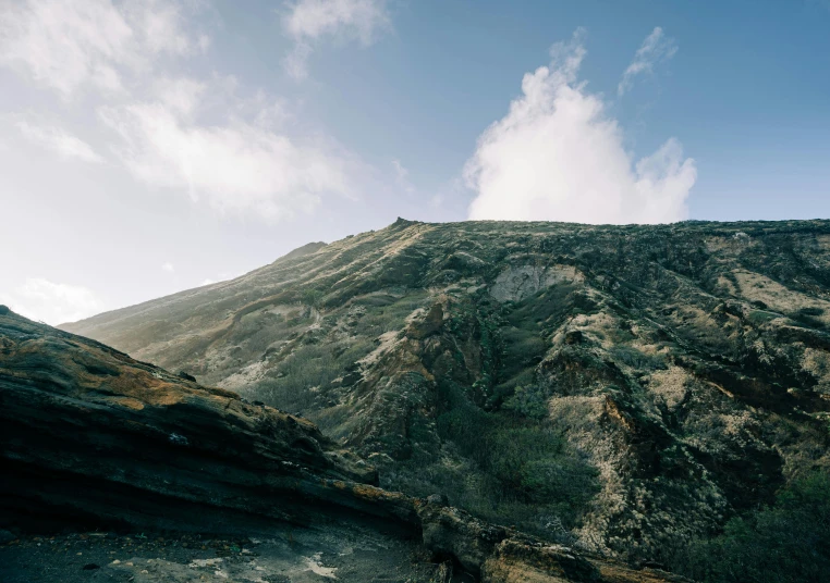 an expanse of rocks sits atop a rocky hillside