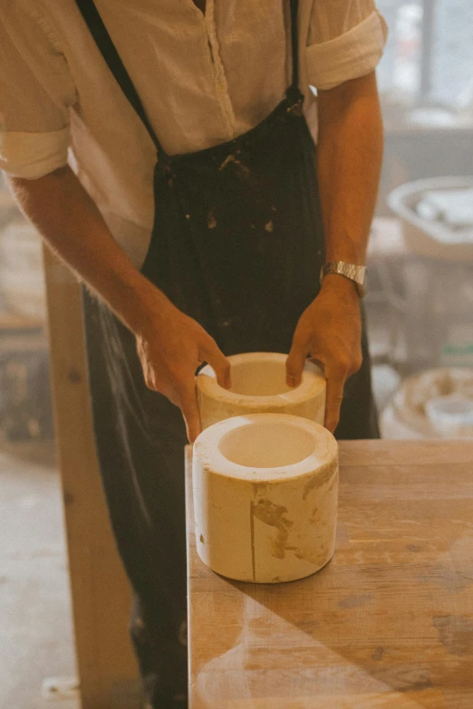 a man is working on a piece of wood, a marble sculpture, inspired by Hendrik Gerritsz Pot, trending on unsplash, o'neill cylinder, made of glazed, thick lining, alex heywood
