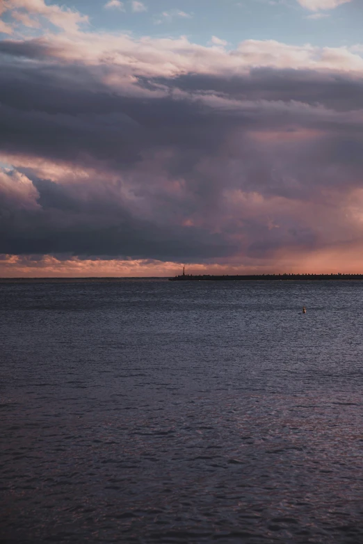 the water is dark and blue with white clouds