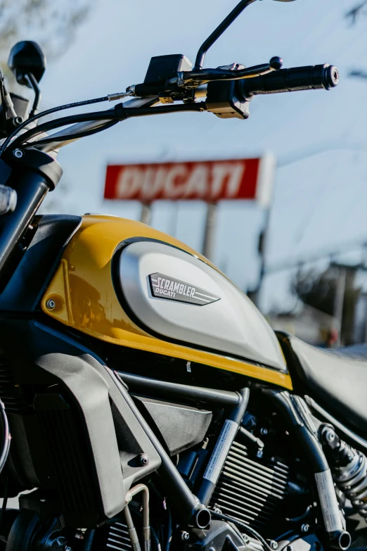 a motorcycle sits parked outside near a sign