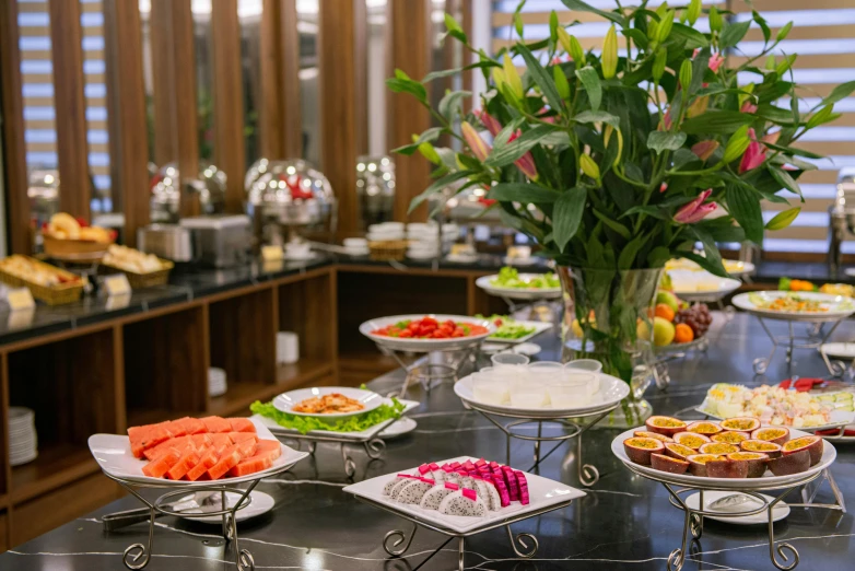 a table topped with plates of food next to a vase of flowers, breakfast buffet, yuli ban, hotel, thumbnail