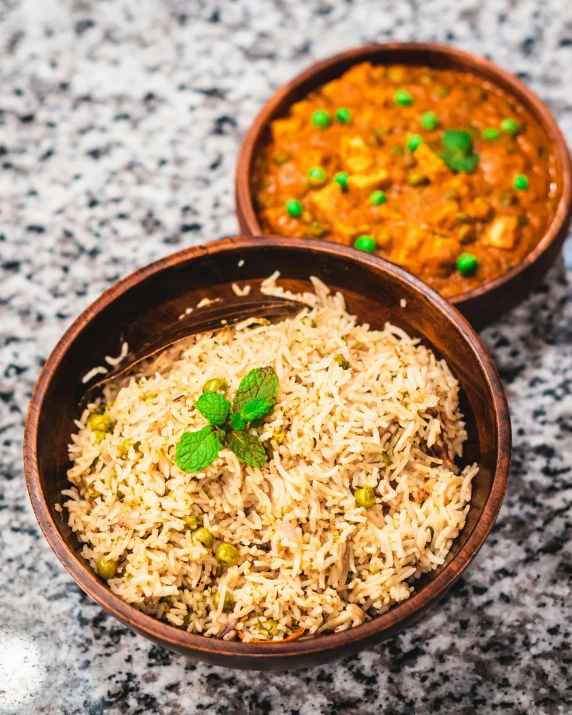 a couple of wooden bowls filled with food on a table