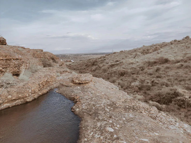 a view from a hill above the water