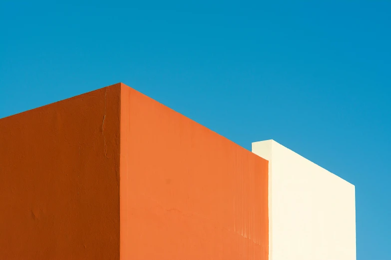 a red and white building with a blue sky in the background, inspired by Ricardo Bofill, unsplash contest winner, postminimalism, ochre, fully rendered light to shadow, minimalist photorealist, blue and orange