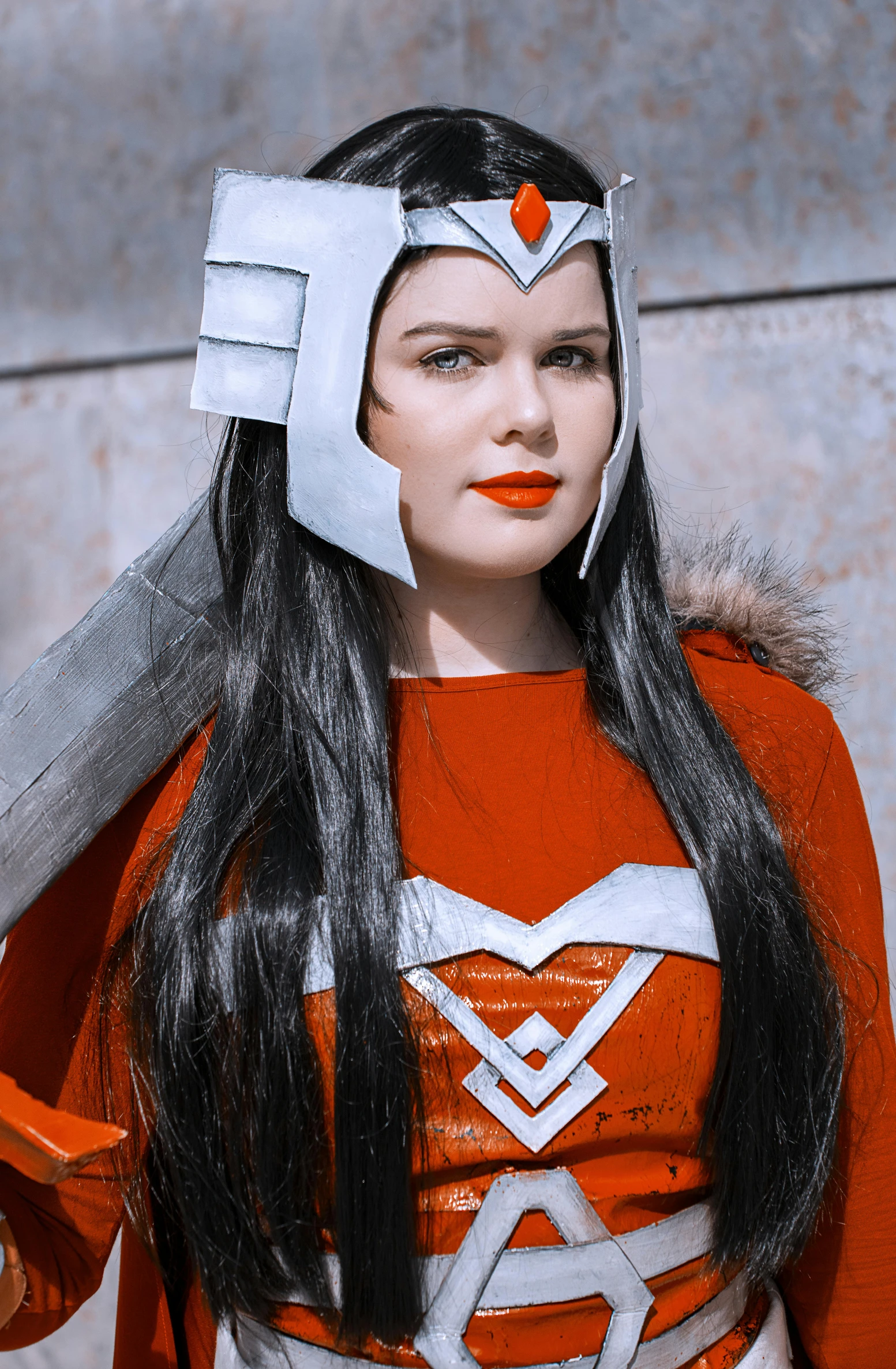 a woman dressed in orange and white outfit with scissors