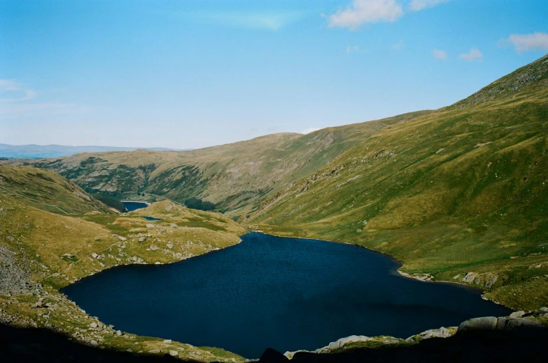 a large blue body of water in the middle of mountains