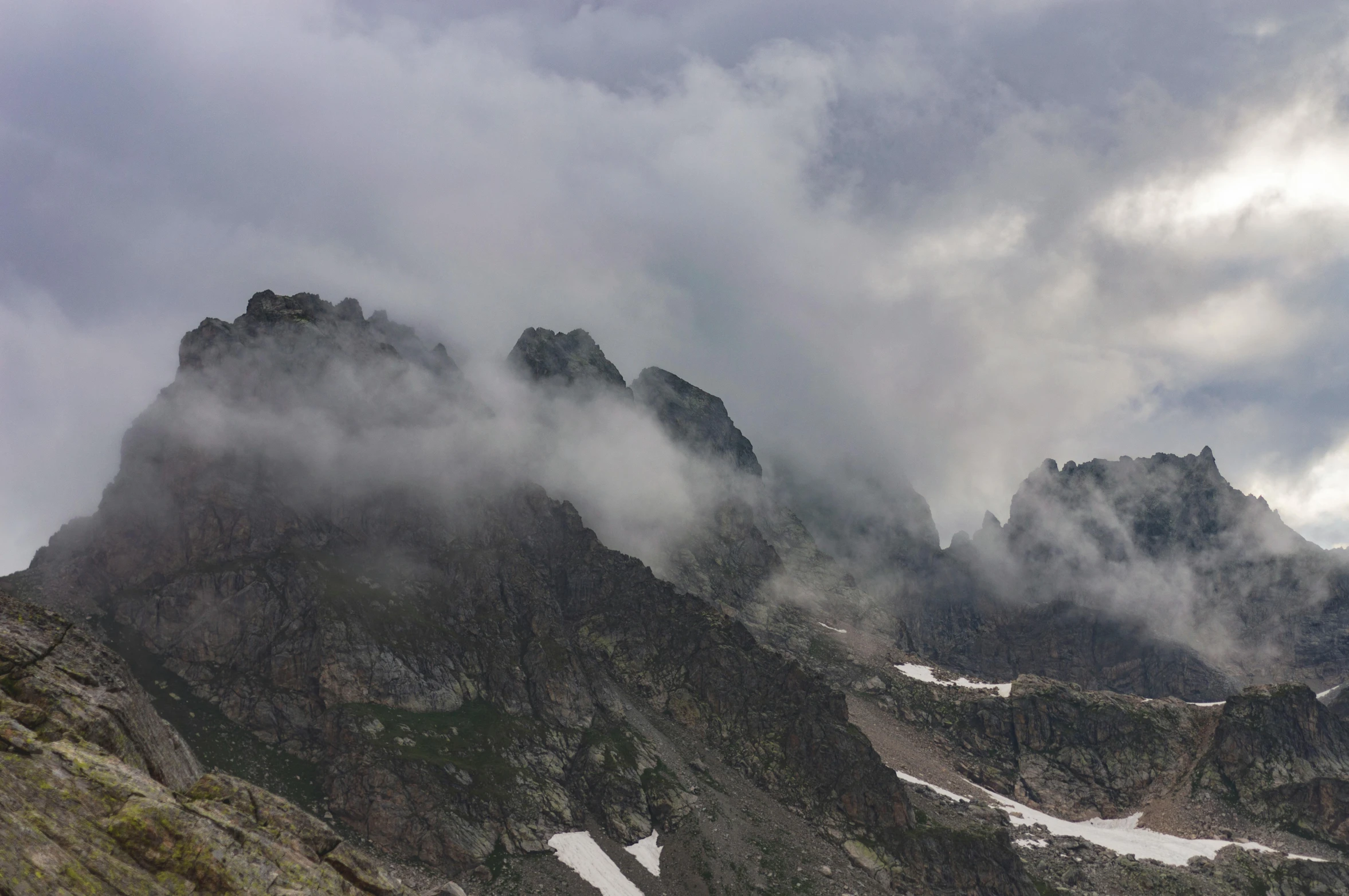 a group of mountains surrounded by clouds