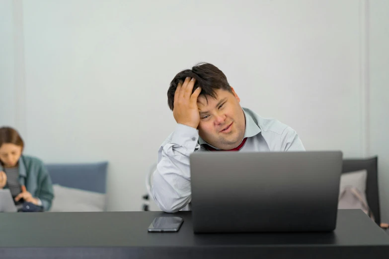 a man sitting at a table with a laptop in front of him, oops, obese, looking exhausted, avatar image