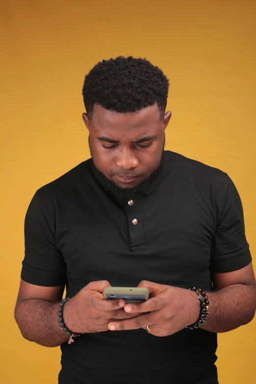 a man in a black shirt looking at his cell phone, by Chinwe Chukwuogo-Roy, tachisme, lgbtq, yellow hue, square, screensaver