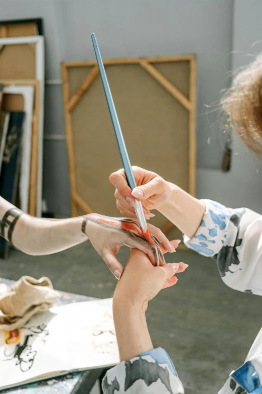 a woman cutting another woman's hair with scissors, a hyperrealistic painting, inspired by Jacques-Louis David, trending on pexels, arbeitsrat für kunst, drawing an arrow from his quiver, children drawing with pencils, four hands, in a studio