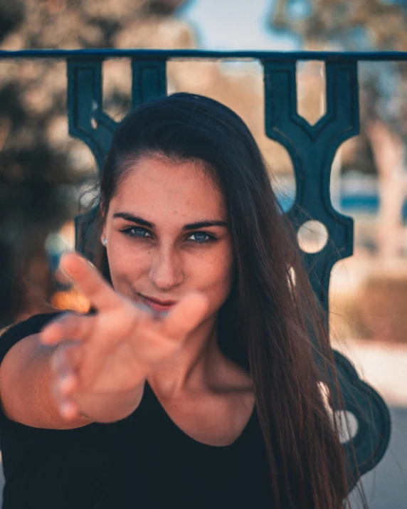 a woman pointing her finger at the camera, pexels contest winner, happening, non binary model, 2019 trending photo, welcoming smile, symmetric face
