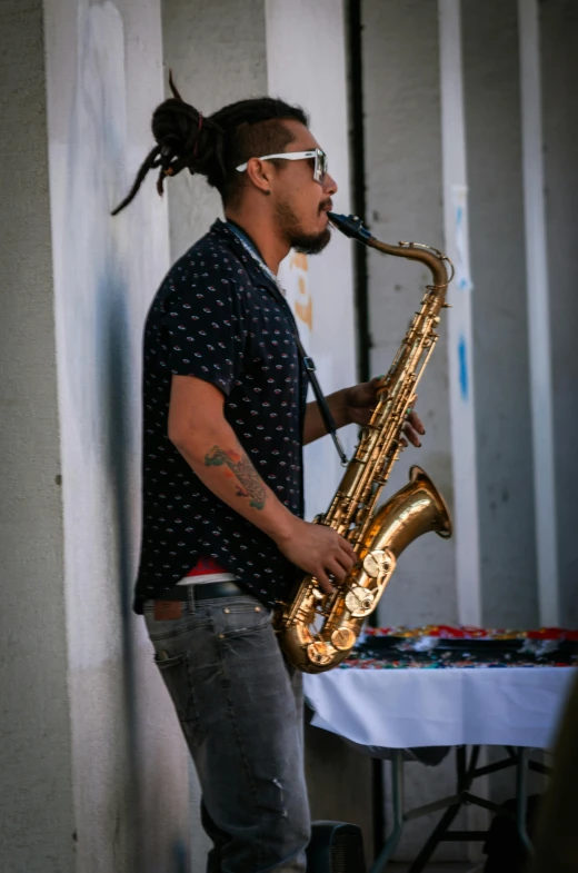 a man in a bandana is playing a saxophone