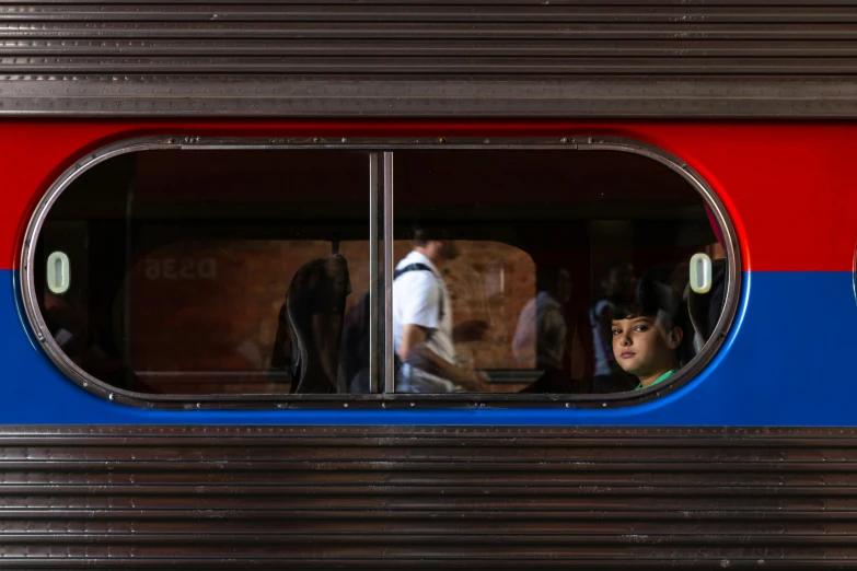 a group of people looking out of a train window, by Pedro Pedraja, red brown and blue color scheme, puerto rico, central station in sydney, dezeen