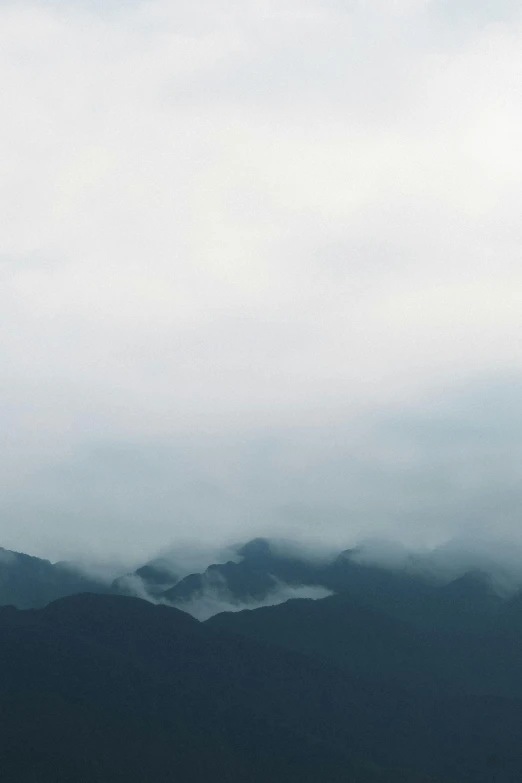 a distant image of mountains in the distance with clouds