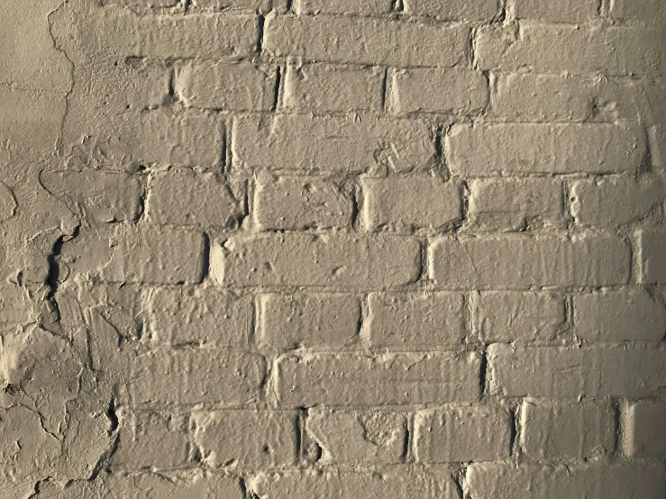 the old wall is white with small, uneven brickwork