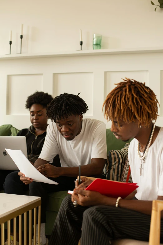 a group of people sitting on a couch with laptops, trending on pexels, black arts movement, papers on table, black teenage boy, scholarly, slide show