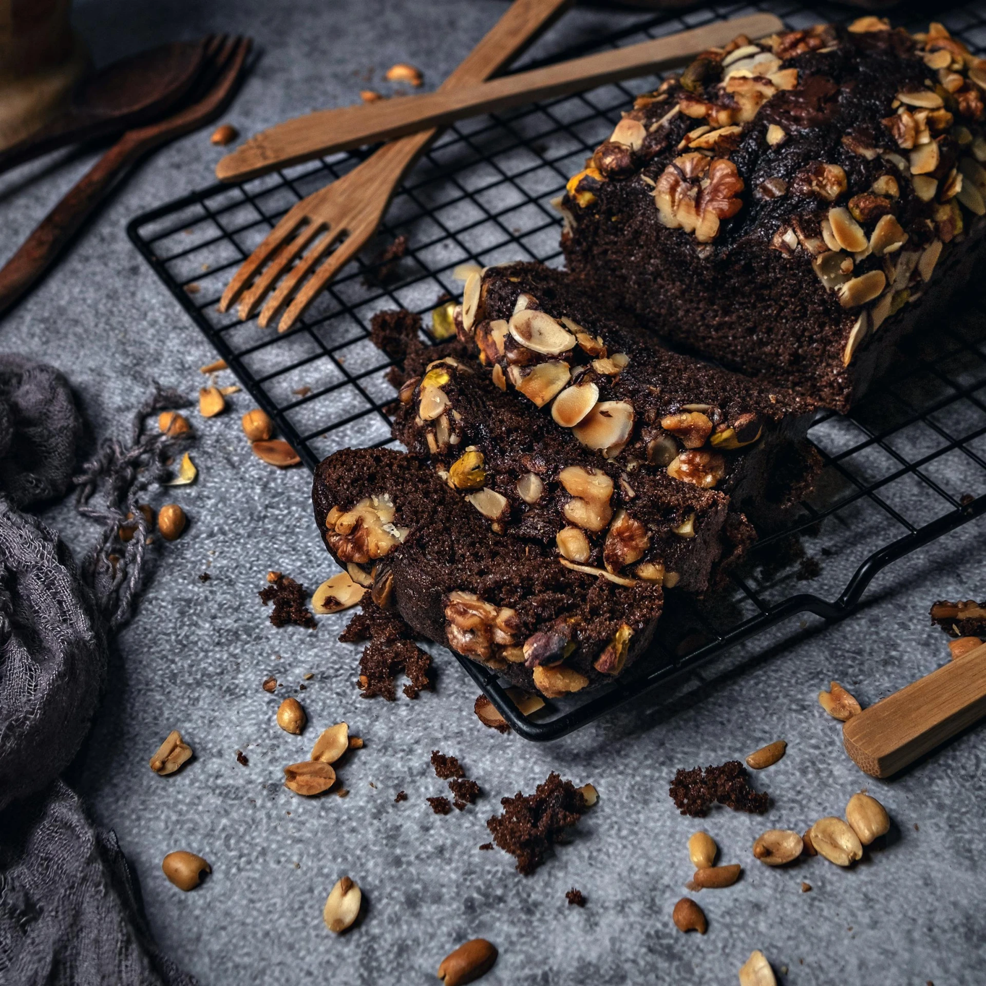 a loaf of chocolate bread sitting on top of a cooling rack, by Andries Stock, shutterstock contest winner, renaissance, rocky roads, 👰 🏇 ❌ 🍃, product design shot, brown dark hair