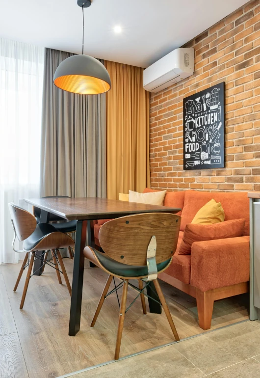 a kitchen area with a couch and chair