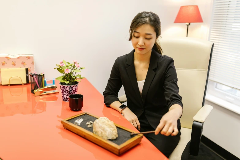 a lady that is  into a food item on a tray