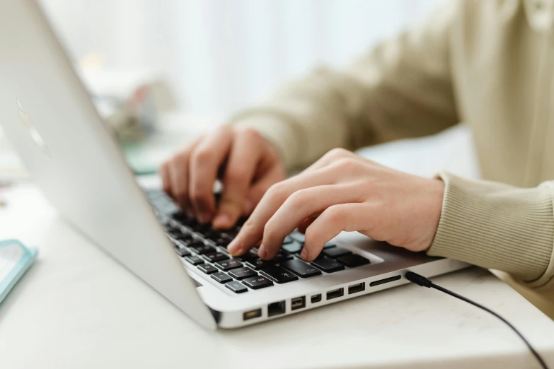 a close up of a person typing on a laptop, by Carey Morris, trending on pexels, avatar image, student, light toned, technical