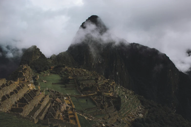 the clouds and fog rolling in over a mountain