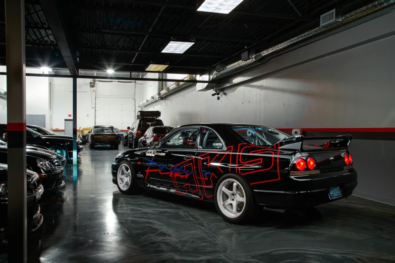 a group of cars are parked inside of a garage