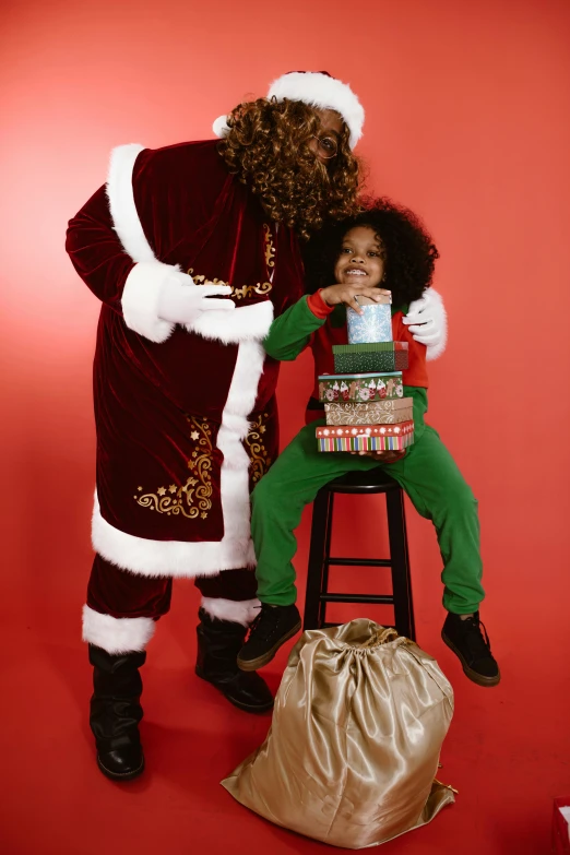 two children posing for a pograph with a santa costume