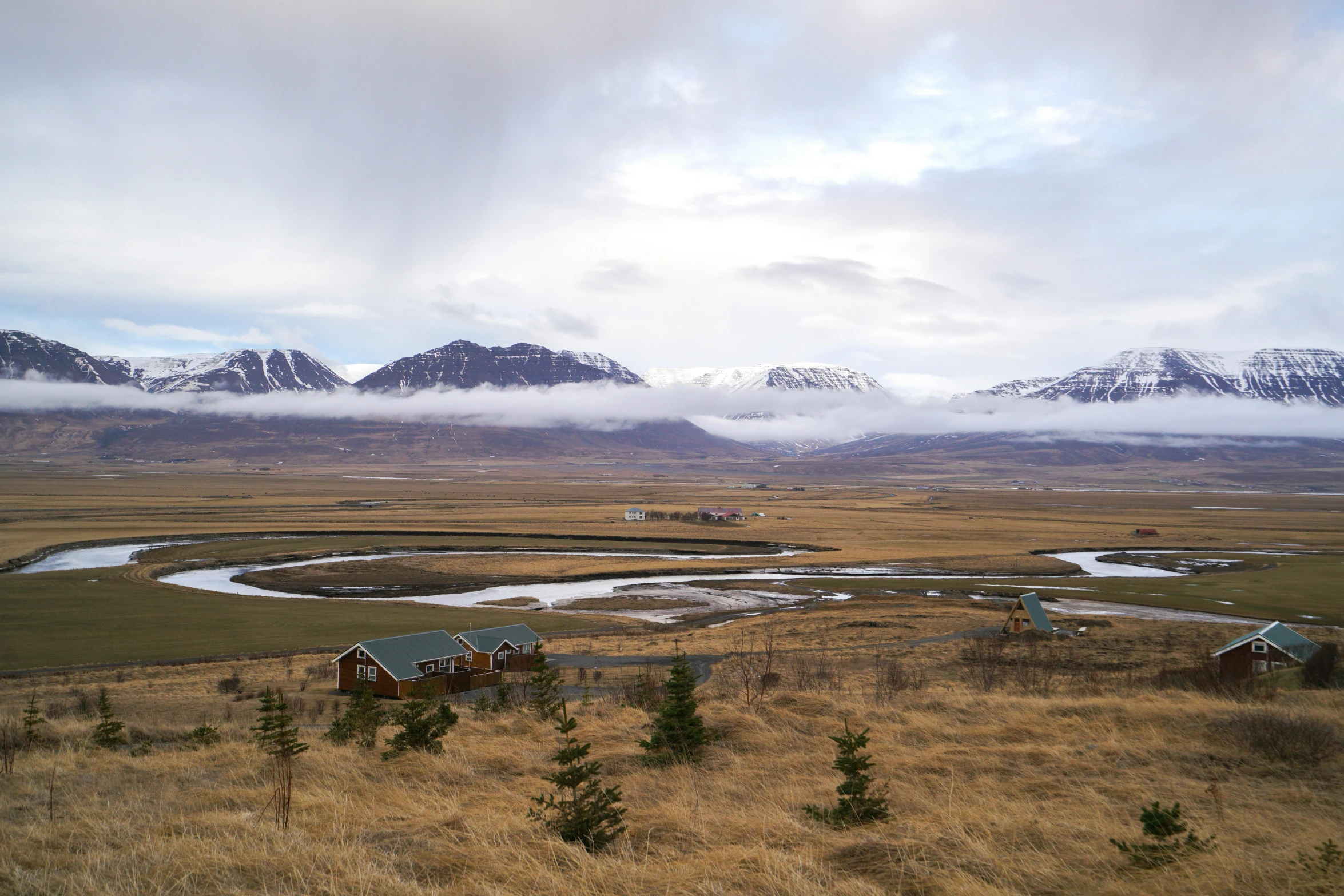 view of the mountain range with clouds and a river