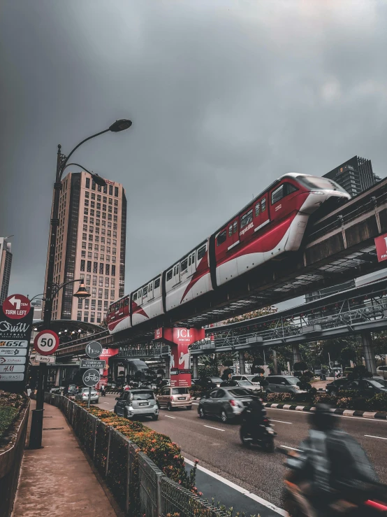 a street filled with lots of traffic next to tall buildings, inspired by Steve McCurry, pexels contest winner, hyperrealism, monorail station, south jakarta, today\'s featured photograph 4k, white and red color scheme