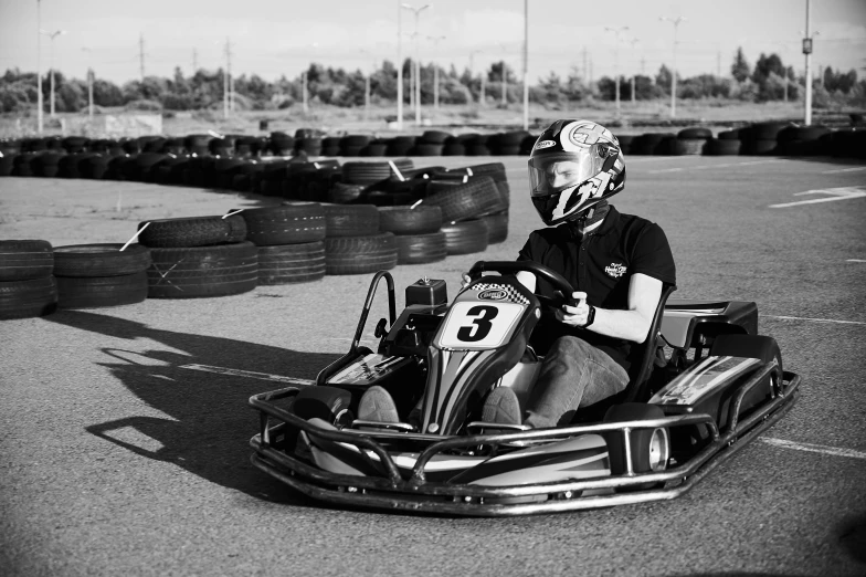 a black and white photo of a person in a go kart, ekaterina, brilliant, square, high quality photo