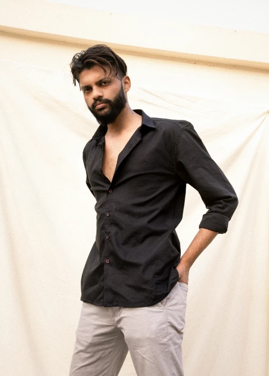 a bearded man posing for a picture on his wedding day