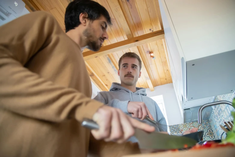 a couple of men standing next to each other in a kitchen, a picture, chopping hands, profile image, thumbnail, college