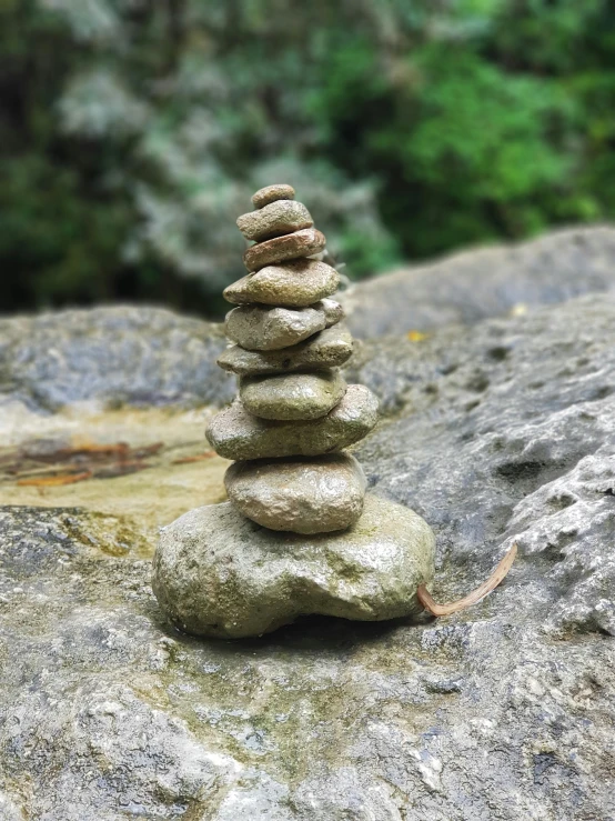 a pile of rocks sitting on top of a rock, inspired by Andy Goldsworthy, small, hanging, mini model, ((rocks))