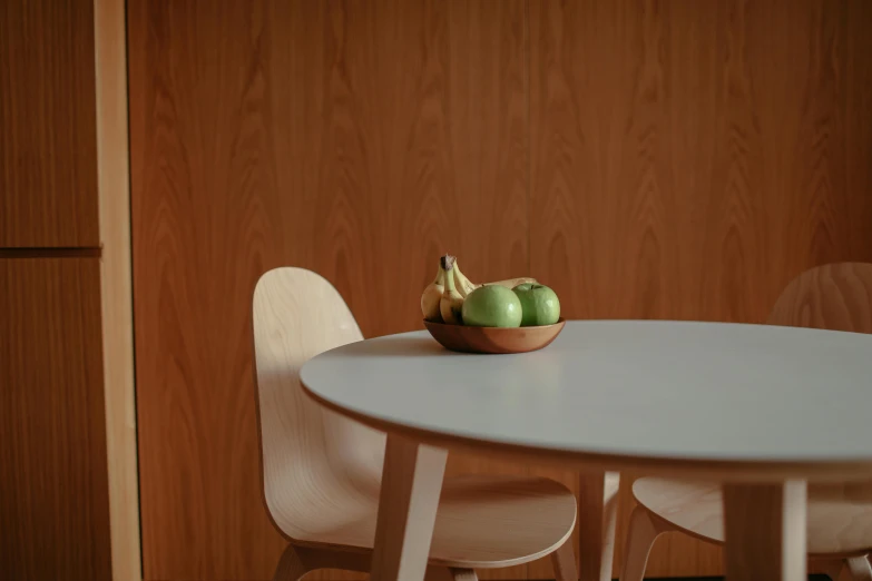 some green apples are sitting on a white table