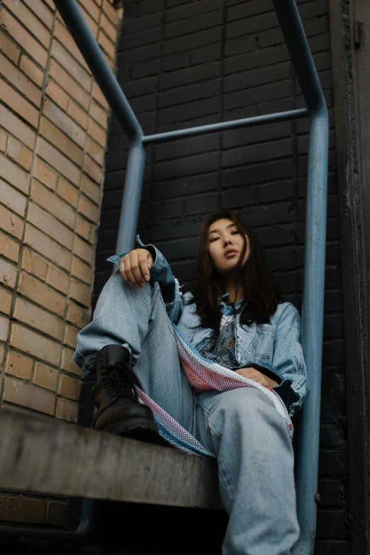 an asian girl sitting on some steps