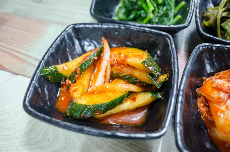 a close up of bowls of food on a table, inspired by Nam Gye-u, unsplash, mingei, pickles, square, spicy, made of glazed