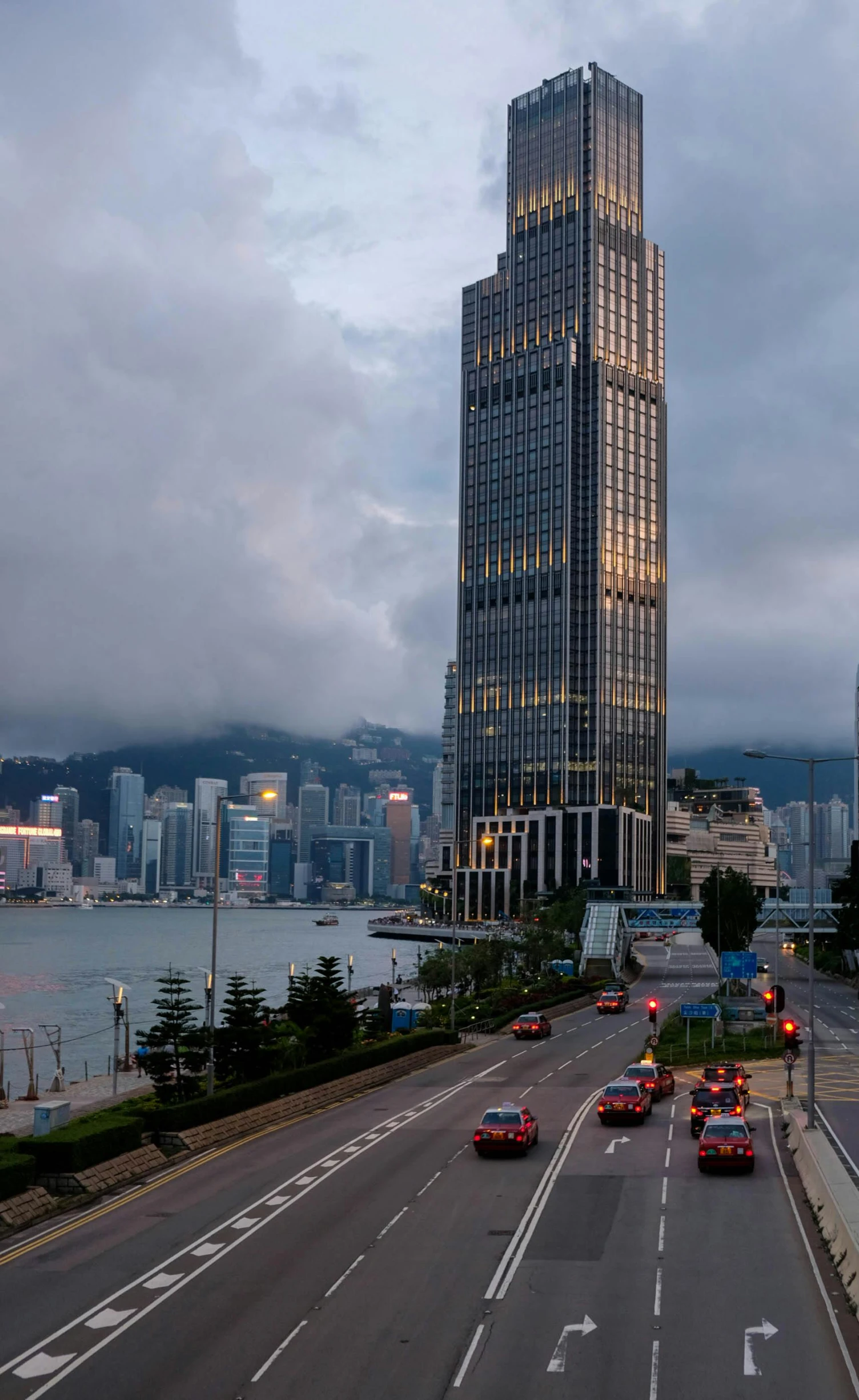 a tall building on the side of a road next to some water