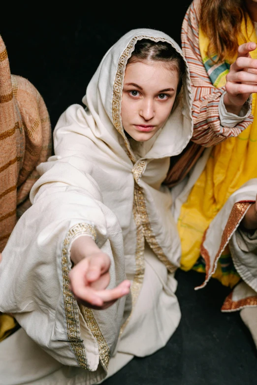 a group of people dressed as jesus and mary, inspired by Andrei Rublev, unsplash, renaissance, pointing, tech robes, female dancer, high angle close up shot