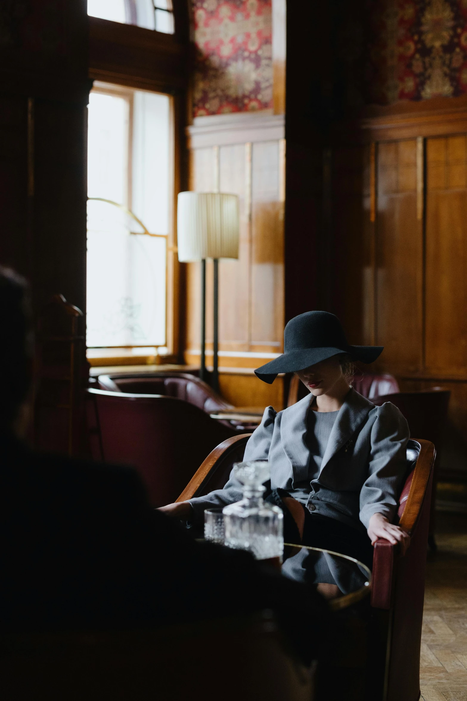 a man wearing a hat sitting down in a restaurant