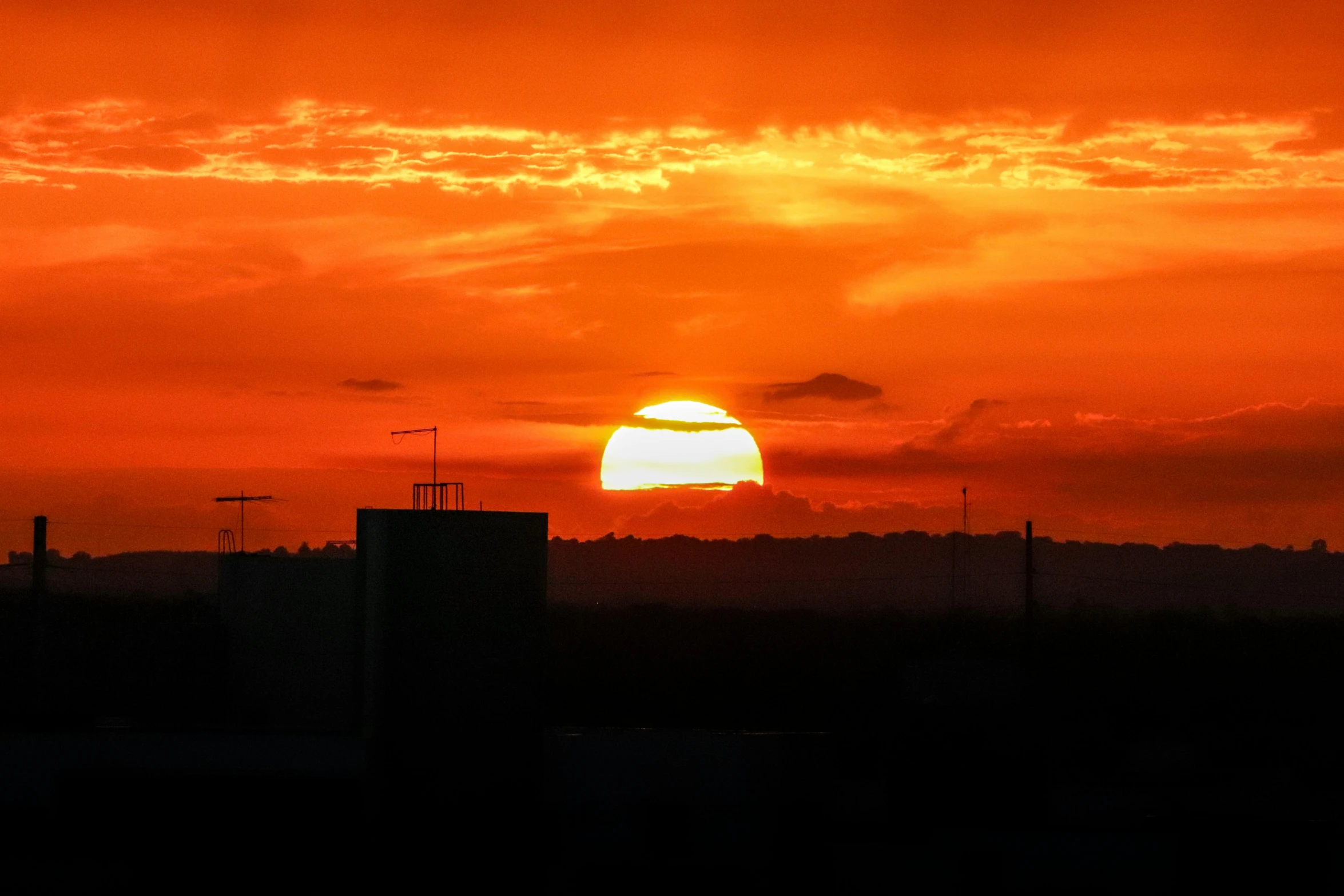 the sun is setting over the city skyline, a picture, by Ian Fairweather, happening, digital yellow red sun, ((sunset)), solar, orange sun set