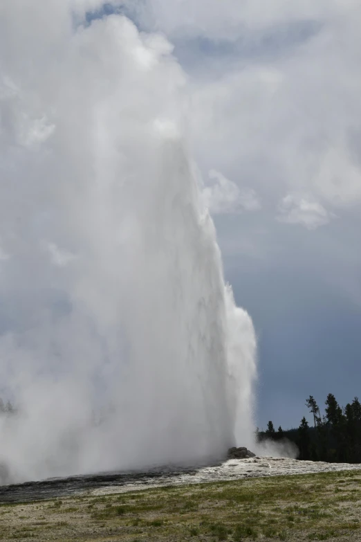 a geyser is spewing out of the ground