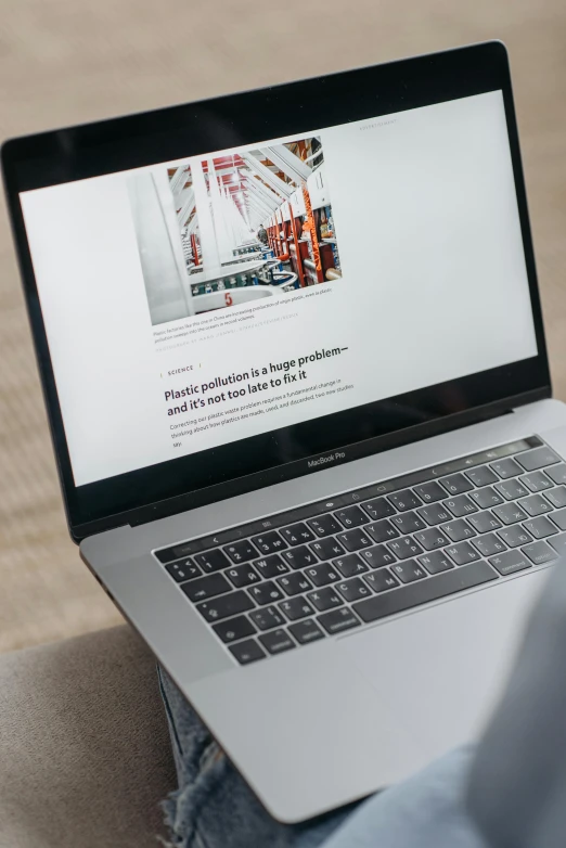 a person sitting on a couch using a laptop, pexels contest winner, construction, close up to the screen, grey, with full descriptions