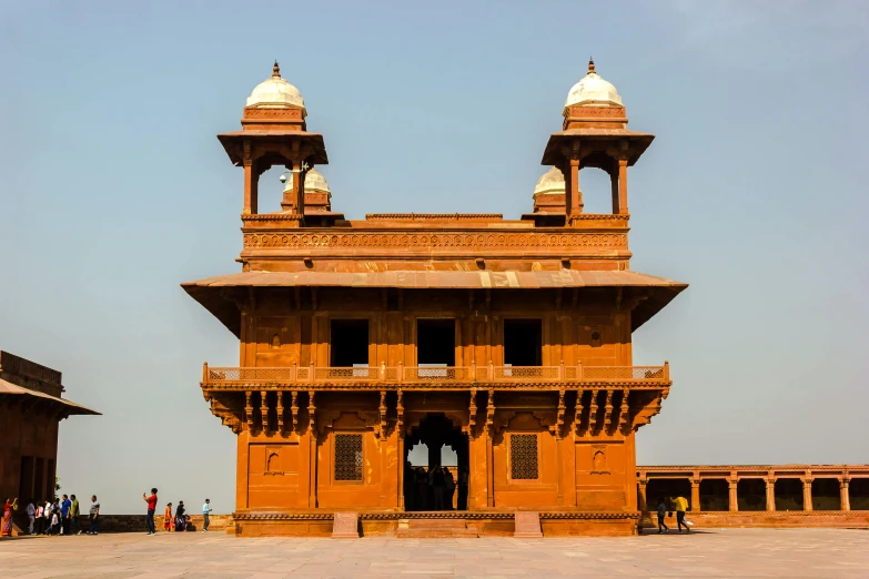 a large building with two towers on top of it, by Julia Pishtar, india, fan favorite, red ocher, square