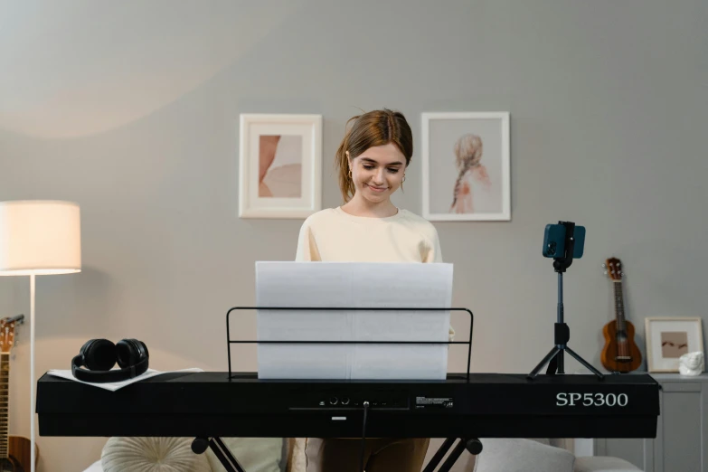 a woman sitting at a keyboard in a living room, by Emma Andijewska, avatar image