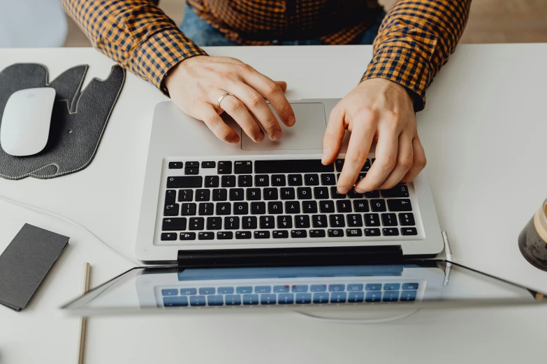 a close up of a person typing on a laptop, trending on pexels, avatar image, background image, high angle shot, professional image