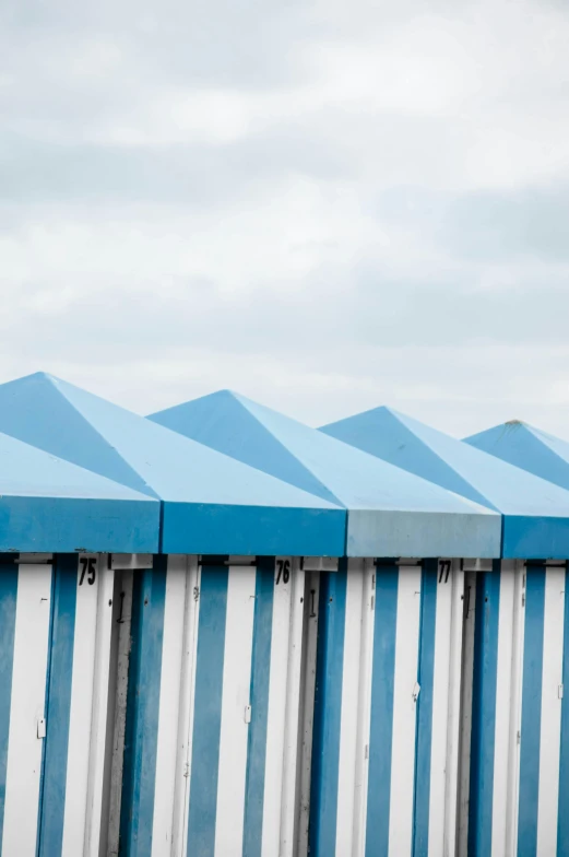 a set of four identical blue and white striped buildings